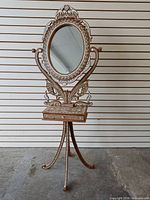 Full view of bone inlaid standing mirror on tripod base