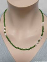 Necklace front view on bust showing jade and pearl arrangement