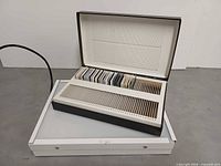 Slide storage case open on top of illuminated light box