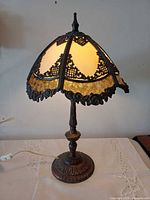 lamp lit, showing slag glass shade and base