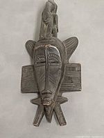 Front view of carved wooden mask showing full design