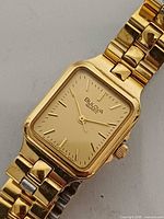 Front view of Bulova gold-tone quartz rectangular wristwatch showing dial and bracelet