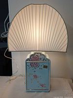 Lamp illuminated showing shade and ceramic body