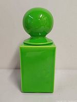 Front view of Sicart green ceramic jar with spherical lid