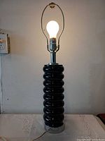 Lamp illuminated showing full height with harp and lit bulb