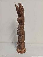 Front view of carved wooden totem pole