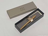 Box with Parker branding opened showing pen and booklet
