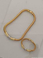 Necklace and bracelet laid flat showing overall design