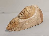 Front/side view of soapstone carving showing primary mask details