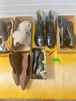 Six boxed pairs of vintage footwear overview