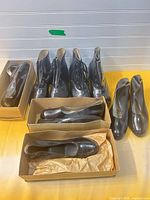 Overview showing two boxed slip-on overshoes and two pairs lace-up boots