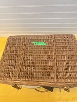 Closed wicker basket with lid showing lot identification