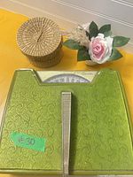 Top view of scale, wicker basket with lid, floral decor