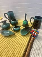 Full group showing all glazed pieces with Rubik's cube for scale