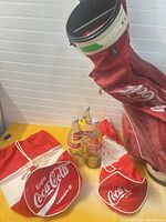 Lot overview showing golf bag, three bottles and two nylon bags