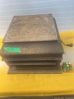 Closed gramophone showing wood case and front louvers