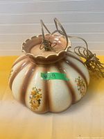 Top view of scalloped ceramic hanging lamp with wiring and floral decals