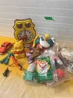 Group shot of entire lot showing clock, plane, figures, sealed toys