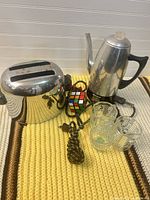 Toaster, electric kettle, three glass creamers displayed together