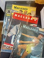 Stack of five bagged Maclean's magazines showing various cover art