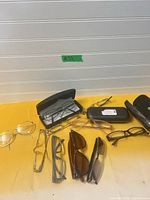 Overall view of ten pairs of eyewear and two cases