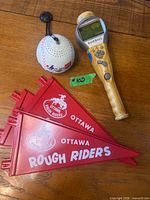 Front view of baseball radio, bat game, three Rough Riders flags