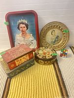 Group showing both trays and three tins