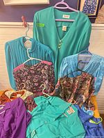 Eight of the dresses laid out showing color variety and labels