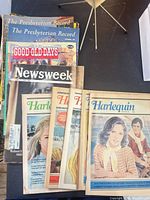 Stack of assorted vintage magazines including Harlequin, Newsweek, Good Old Days and The Presbyterian Record visible