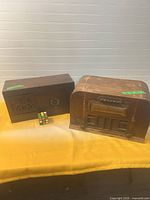 Two wooden tabletop radios on table