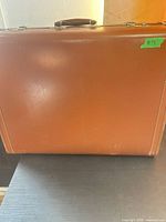 Front view of brown hard-sided suitcase