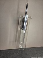 Full view of pendant light with glass cylinder and inner chrome parts