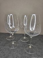 Four Riedel crystal wine glasses upright
