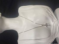 Necklace displayed on mannequin torso showing chain length and pendant size