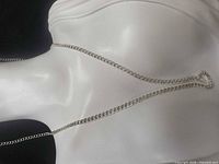 Full view of sterling silver curb chain on display bust