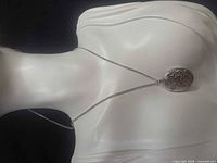 Necklace on display bust showing overall design and chain length