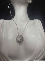 Full view of necklace on bust displaying chain length and pendant placement