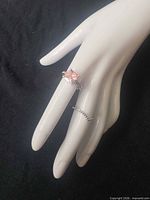Ring set on mannequin hand showing solitaire ring and matching band