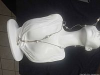 Full view of necklace on bust form showing overall design and pearl placement