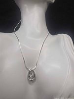 Necklace displayed on bust showing chain length and pendant placement