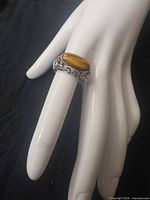 Ring on display hand showing top view with tiger's eye stone