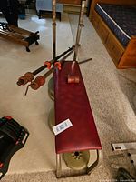 Bench with plates stacked beneath and bars resting on top