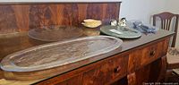Overview of platters, marble board, small plates, cat shakers, flatware