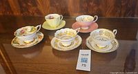 Group shot of five teacup and saucer sets