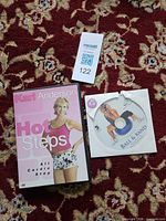 Kari Anderson Hot Steps DVD case with cover alongside Simply Ball & Band loose disc in paper sleeve on patterned rug