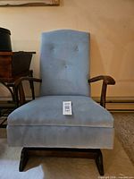 Front view of light blue tufted rocking chair