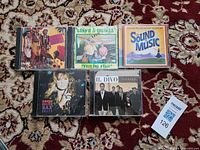 All five CDs laid out showing front covers, including Il Divo, Sound of Music, Candy Dulfer and two unidentified titles