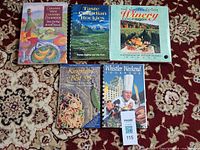 All five cookbooks laid out, showing titles and bindings