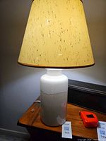 Full lamp with shade on wooden surface