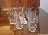 Group of seven faceted tumblers on table